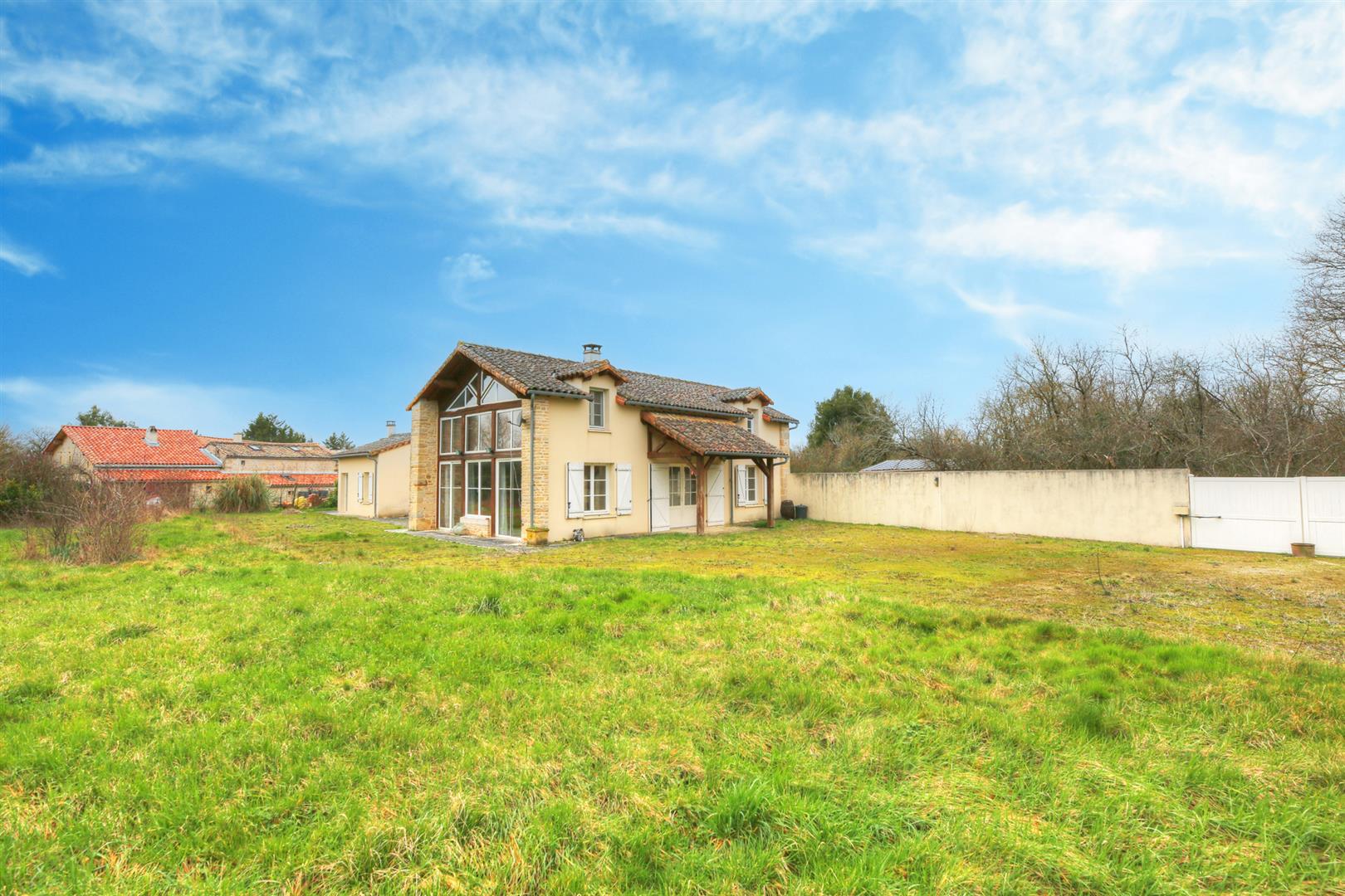 Spacious and light filled barn conversion with guest cottage and 2 acres of gardens.